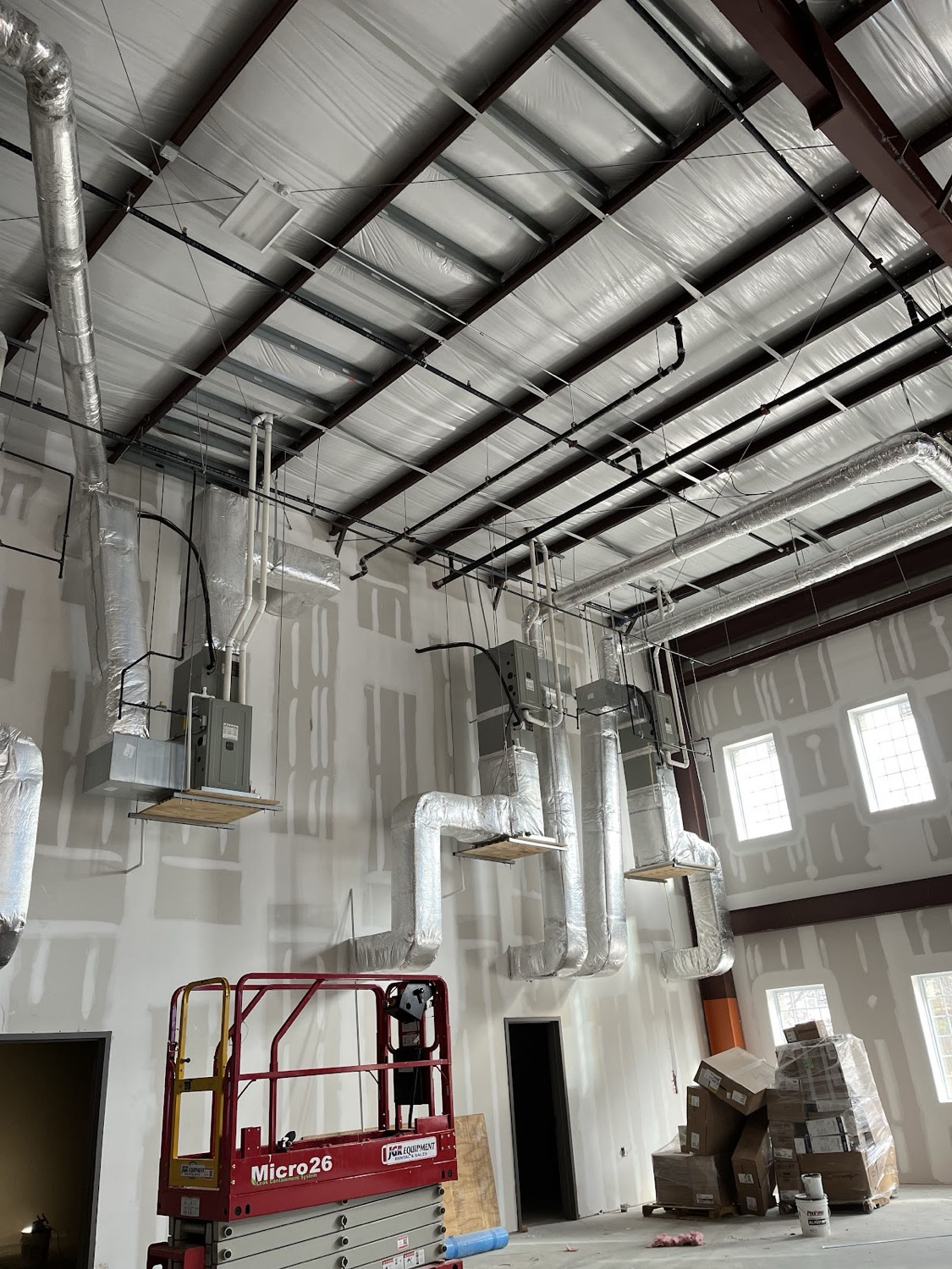 Commercial ductwork installation inside a steel-framed building