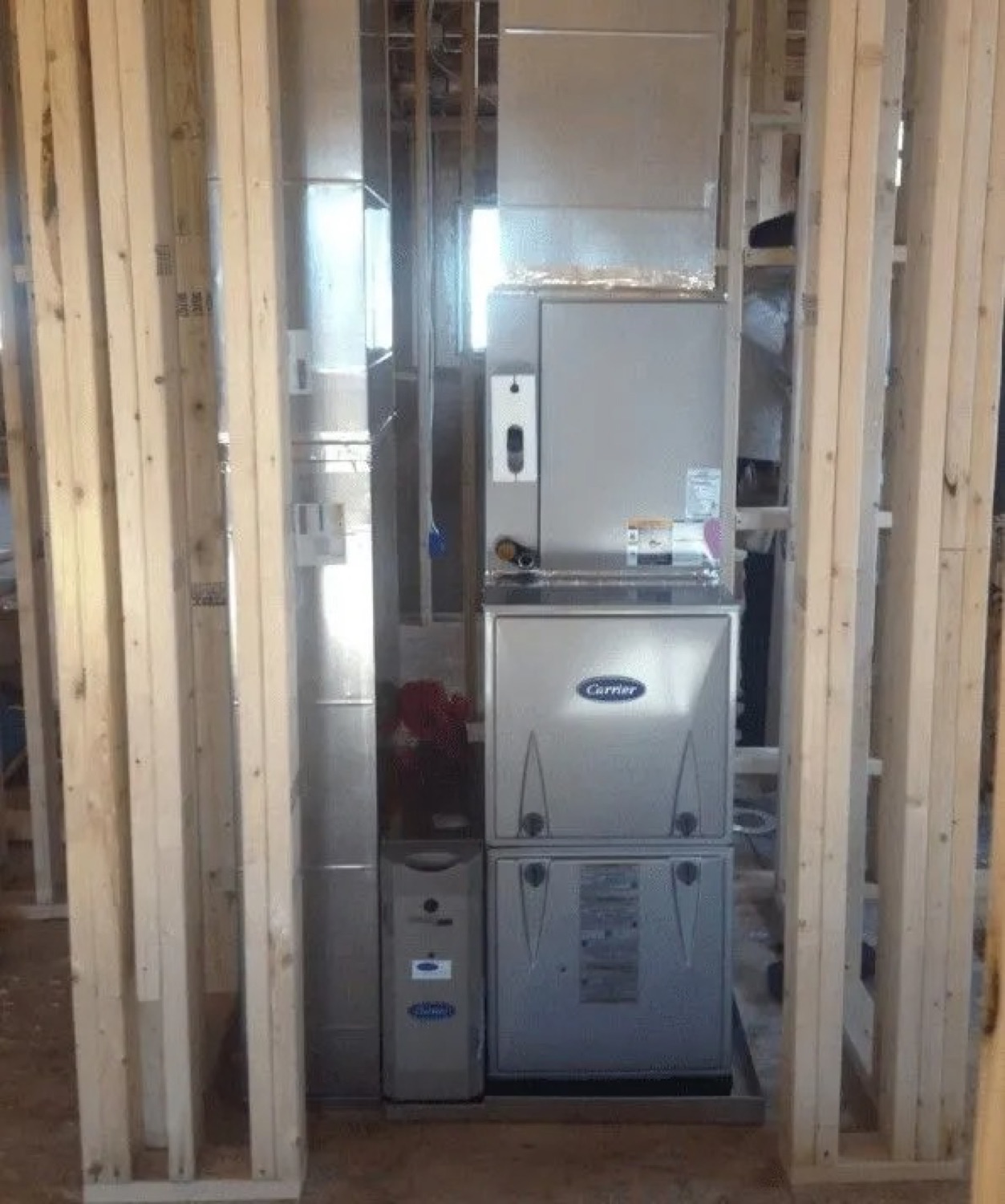 New furnace and air handler installed in a home mechanical room